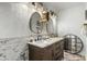 Elegant bathroom with marble counters, double sinks, and decorative lighting at 551 E Sun Valley Farms Ln, San Tan Valley, AZ 85140