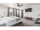 Bedroom with carpet, white walls, large TV, and large windows for ample natural light at 551 E Sun Valley Farms Ln, San Tan Valley, AZ 85140