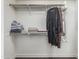 A walk-in closet with clothes hanging and plenty of space for storage at 551 E Sun Valley Farms Ln, San Tan Valley, AZ 85140