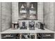 Coffee bar area with marble counters, black cabinetry and many types of coffeemakers at 551 E Sun Valley Farms Ln, San Tan Valley, AZ 85140