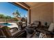 Covered patio featuring comfortable wicker seating, perfect for enjoying the outdoors and relaxation at 551 E Sun Valley Farms Ln, San Tan Valley, AZ 85140