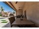 Inviting covered patio featuring a dining table, wicker chairs, and outdoor lighting, creating a comfortable entertaining space at 551 E Sun Valley Farms Ln, San Tan Valley, AZ 85140