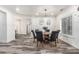 Elegant dining room featuring wood-look floors and modern chandelier at 551 E Sun Valley Farms Ln, San Tan Valley, AZ 85140