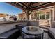 Gazebo featuring a built-in fire table, comfortable seating, and decorative elements, creating a cozy outdoor space at 551 E Sun Valley Farms Ln, San Tan Valley, AZ 85140