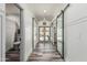 Hallway leading to backyard featuring barn doors and a nearby powder room at 551 E Sun Valley Farms Ln, San Tan Valley, AZ 85140