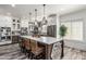 Bright kitchen features a large island with seating, pendant lighting, and modern appliances at 551 E Sun Valley Farms Ln, San Tan Valley, AZ 85140