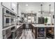 Modern kitchen featuring stainless steel appliances, backsplash, and a spacious island at 551 E Sun Valley Farms Ln, San Tan Valley, AZ 85140