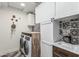 Laundry room with a front-load washer and dryer with lots of room at 551 E Sun Valley Farms Ln, San Tan Valley, AZ 85140