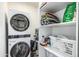 Well-organized laundry area with washer, dryer, and ample shelving for storage at 551 E Sun Valley Farms Ln, San Tan Valley, AZ 85140