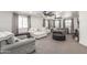 Spacious living room featuring neutral tones, large windows, and contemporary furniture at 551 E Sun Valley Farms Ln, San Tan Valley, AZ 85140