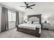 Main bedroom with a large upholstered headboard, soft lighting and neutral colors at 551 E Sun Valley Farms Ln, San Tan Valley, AZ 85140