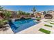 Resort-style pool with comfortable seating, waterfall features, and meticulous landscaping at 551 E Sun Valley Farms Ln, San Tan Valley, AZ 85140