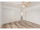 Bedroom with light grey wood flooring, closet, and a neutral palette for versatile décor at 5721 W Palo Verde Ave, Glendale, AZ 85302