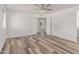 Bedroom with modern ceiling fan, wood-look floors, and neutral paint at 5721 W Palo Verde Ave, Glendale, AZ 85302