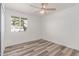 Bedroom with light wood floors, window with a view, offering comfort and simplicity at 5721 W Palo Verde Ave, Glendale, AZ 85302