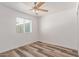 A clean and cozy bedroom boasts light wood floors and a bright, airy window at 5721 W Palo Verde Ave, Glendale, AZ 85302
