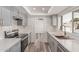 Updated kitchen with gray cabinets, stainless steel appliances, and quartz countertops at 5721 W Palo Verde Ave, Glendale, AZ 85302