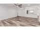 Spacious living room with wood-look floors, neutral walls, and modern ceiling fan at 5721 W Palo Verde Ave, Glendale, AZ 85302