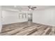 Open concept living room with light wood flooring, ceiling fan, and lots of light at 5721 W Palo Verde Ave, Glendale, AZ 85302
