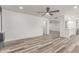 Open concept living room featuring light wood flooring, neutral walls, and ceiling fan at 5721 W Palo Verde Ave, Glendale, AZ 85302