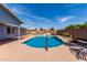 Backyard pool with lounge chairs, grill, and privacy fence, perfect for outdoor entertaining and relaxation at 5721 W Palo Verde Ave, Glendale, AZ 85302