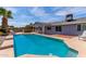 Backyard pool with covered patio and outdoor seating offering shade and relaxation, seamlessly integrated with the home's design at 5721 W Palo Verde Ave, Glendale, AZ 85302