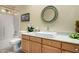 Bright bathroom with upgraded sink, countertop and a round, decorative mirror at 5830 E Mckellips Rd # 120, Mesa, AZ 85215
