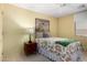 Cozy bedroom with a floral bedspread, side table, and a window with natural light at 5830 E Mckellips Rd # 120, Mesa, AZ 85215