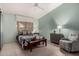 Bedroom with soft green walls, tile flooring, comfortable seating, and a queen bed at 5830 E Mckellips Rd # 120, Mesa, AZ 85215