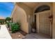 Close-up view of front entrance with decorative shrubs and a security door at 5830 E Mckellips Rd # 120, Mesa, AZ 85215