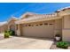 Close-up view of charming single-story home featuring a desert landscape and an attached two-car garage at 5830 E Mckellips Rd # 120, Mesa, AZ 85215
