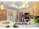 Kitchen with stainless steel appliances, double sink, bright lighting, and adjacent laundry room at 5830 E Mckellips Rd # 120, Mesa, AZ 85215