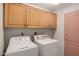 Convenient laundry room with cabinetry over the washer and dryer units at 5830 E Mckellips Rd # 120, Mesa, AZ 85215