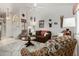 Comfortable living room featuring a ceiling fan, tile flooring, and unique wall decor at 5830 E Mckellips Rd # 120, Mesa, AZ 85215
