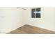 Bright bedroom featuring light wood flooring, a large window, and a closet with sliding doors at 628 N Hobson --, Mesa, AZ 85203