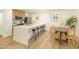 Bright kitchen features quartz countertops, stainless steel appliances, and a dining area with stylish seating at 628 N Hobson --, Mesa, AZ 85203