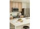 Modern kitchen features stainless steel appliances and a large quartz countertop island at 628 N Hobson --, Mesa, AZ 85203