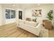 Cozy living room with light wood floors, designer furniture, and abundant natural light at 628 N Hobson --, Mesa, AZ 85203