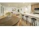 Open concept kitchen and living room features modern lighting, neutral tones, and stylish decor at 628 N Hobson --, Mesa, AZ 85203