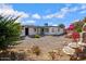 Landscaped backyard features a stone water fountain and desert landscaping for serene outdoor living at 635 N 67Th Pl, Mesa, AZ 85205