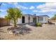 The backyard has a covered patio and xeriscaping for easy care at 635 N 67Th Pl, Mesa, AZ 85205