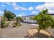 This backyard is adorned with native desert landscaping, including mature cacti and shrubbery at 635 N 67Th Pl, Mesa, AZ 85205