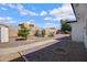 Large backyard features drought-tolerant landscaping, mature trees, and a spacious gravel area at 635 N 67Th Pl, Mesa, AZ 85205