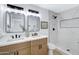 Renovated bathroom with dual sinks and marble tiled shower at 635 N 67Th Pl, Mesa, AZ 85205