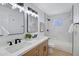 Renovated bathroom with dual sinks, and marble tiled shower at 635 N 67Th Pl, Mesa, AZ 85205