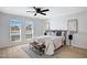 Bright bedroom with a ceiling fan and two large windows at 635 N 67Th Pl, Mesa, AZ 85205