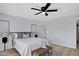 Bedroom with ensuite bath, art, and a ceiling fan at 635 N 67Th Pl, Mesa, AZ 85205