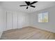 Bright bedroom with a ceiling fan, and three closets at 635 N 67Th Pl, Mesa, AZ 85205