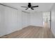 Bedroom features new flooring, ceiling fan, and closets at 635 N 67Th Pl, Mesa, AZ 85205