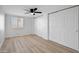Spacious bedroom featuring a ceiling fan, ample closet space, and neutral-toned walls and floors at 635 N 67Th Pl, Mesa, AZ 85205